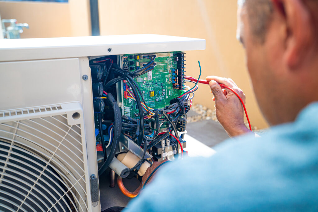 Experienced technician installing AC replacement unit in Las Vegas, NV